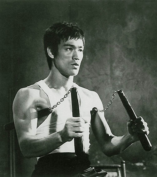 Bruce Lee with his favorite onscreen weapon.